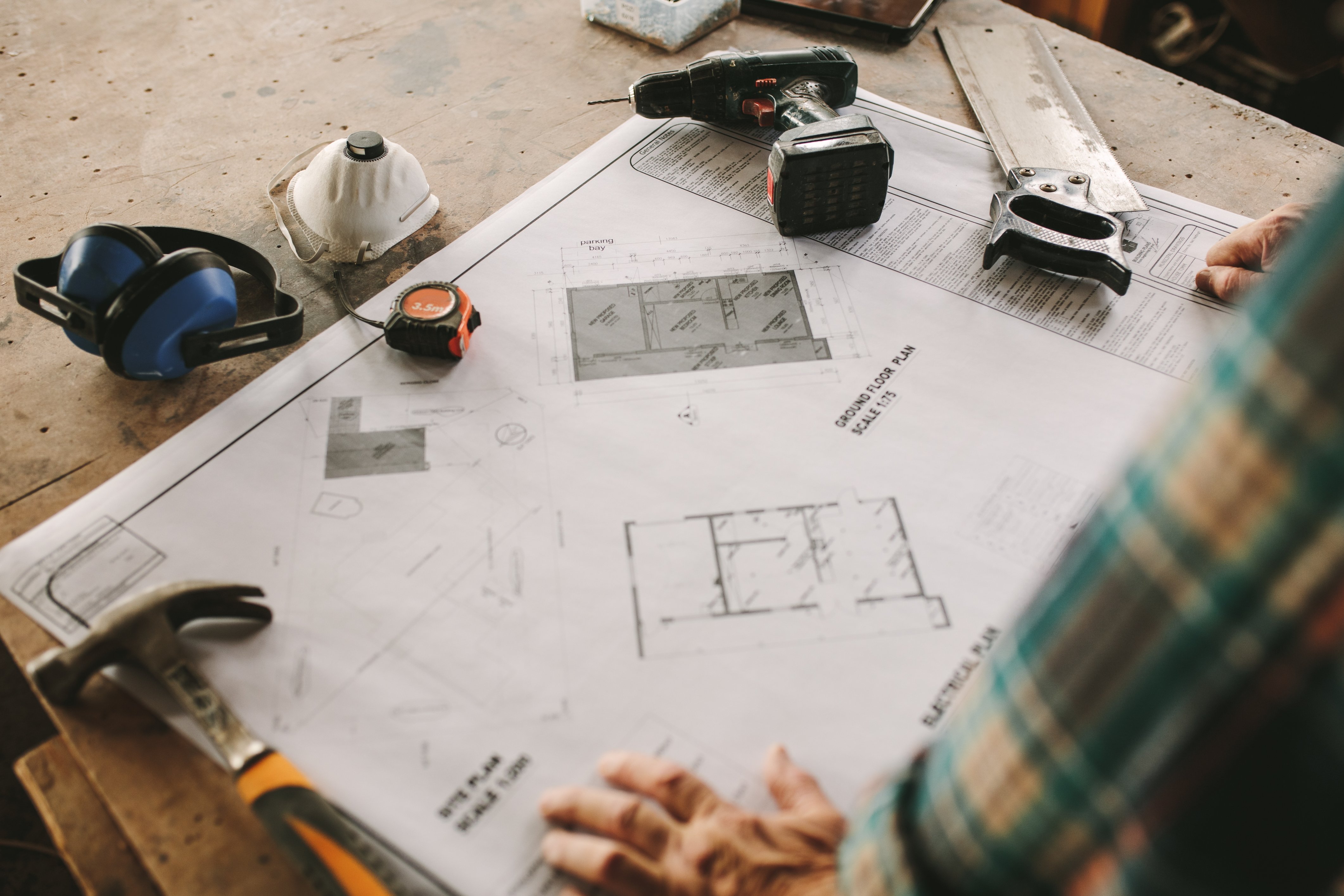 Home remodeler looking over building plans