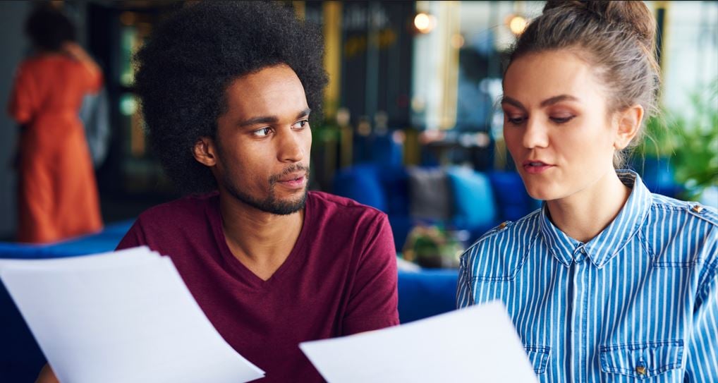 2 people examining documents