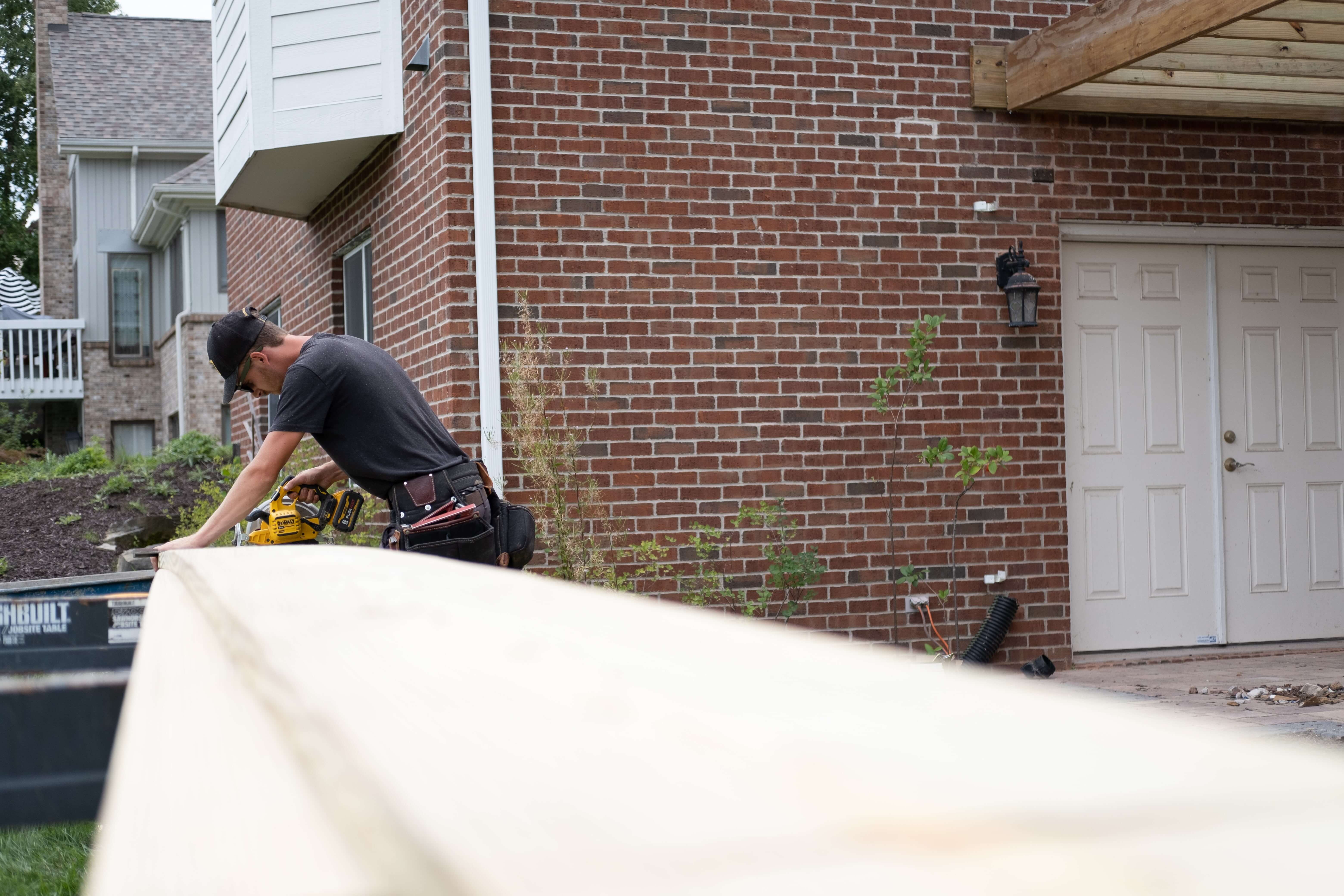 Custom Built carpenter cutting wood for a deck