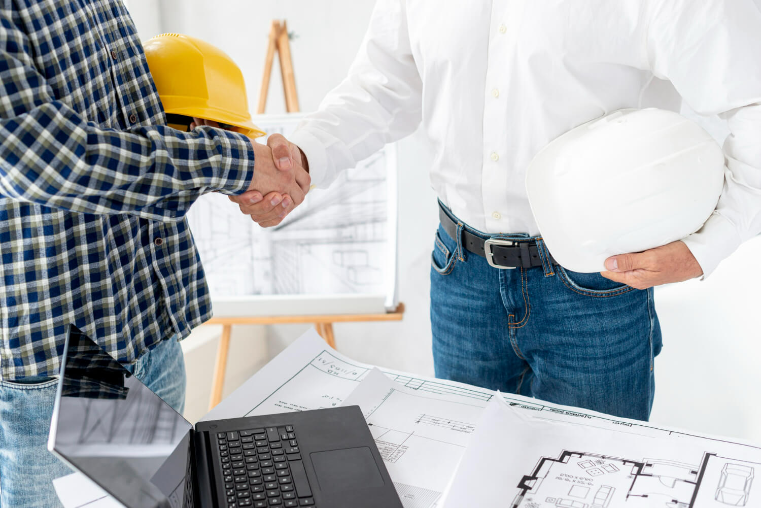 Contractor and client working on project agreement signing meeting construction custom built michigan