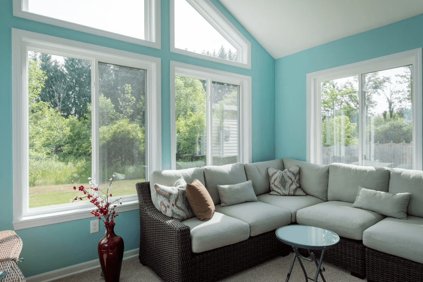 home addition with blue walls and a sectional couch