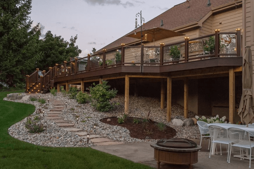 Outdoor living area with stone mulch landscaping and stone steps